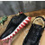 Christian Louboutin Black Leather Gold‑Logo Lace‑Up Sneakers Red Shark‑Tooth Sole