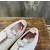 Christian Louboutin White Leather Red‑Trim Spiked Slip‑On Sneakers